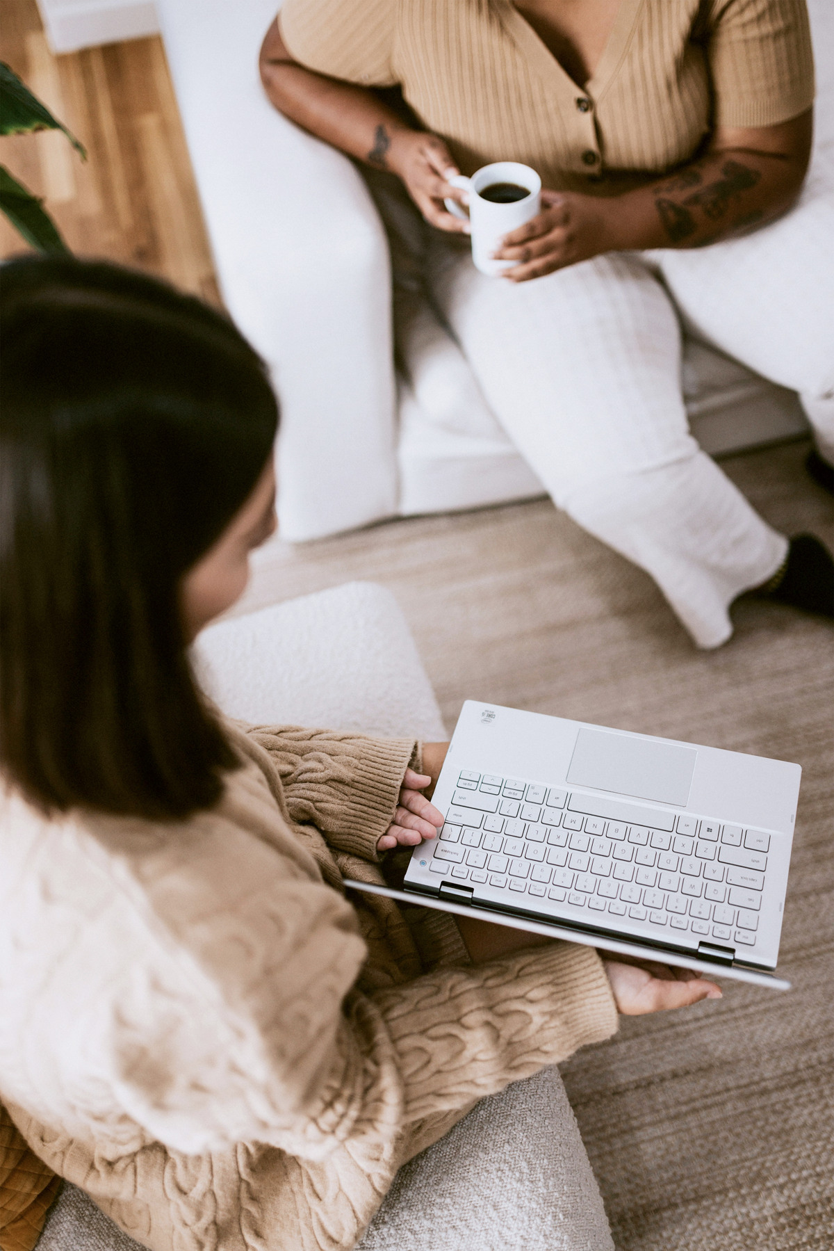 Two people with laptop and coffee.