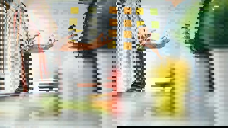 workshopdeltagare diskuterar framför white board