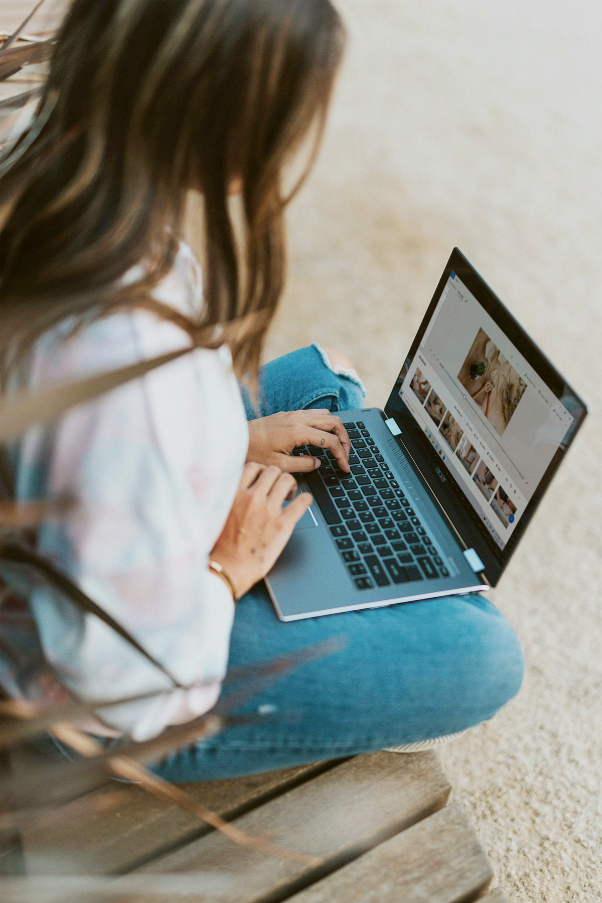 Person using laptop outdoors.